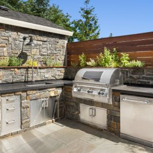 Custom Stone Outdoor Kitchen and Grill Area | A & X Masonry